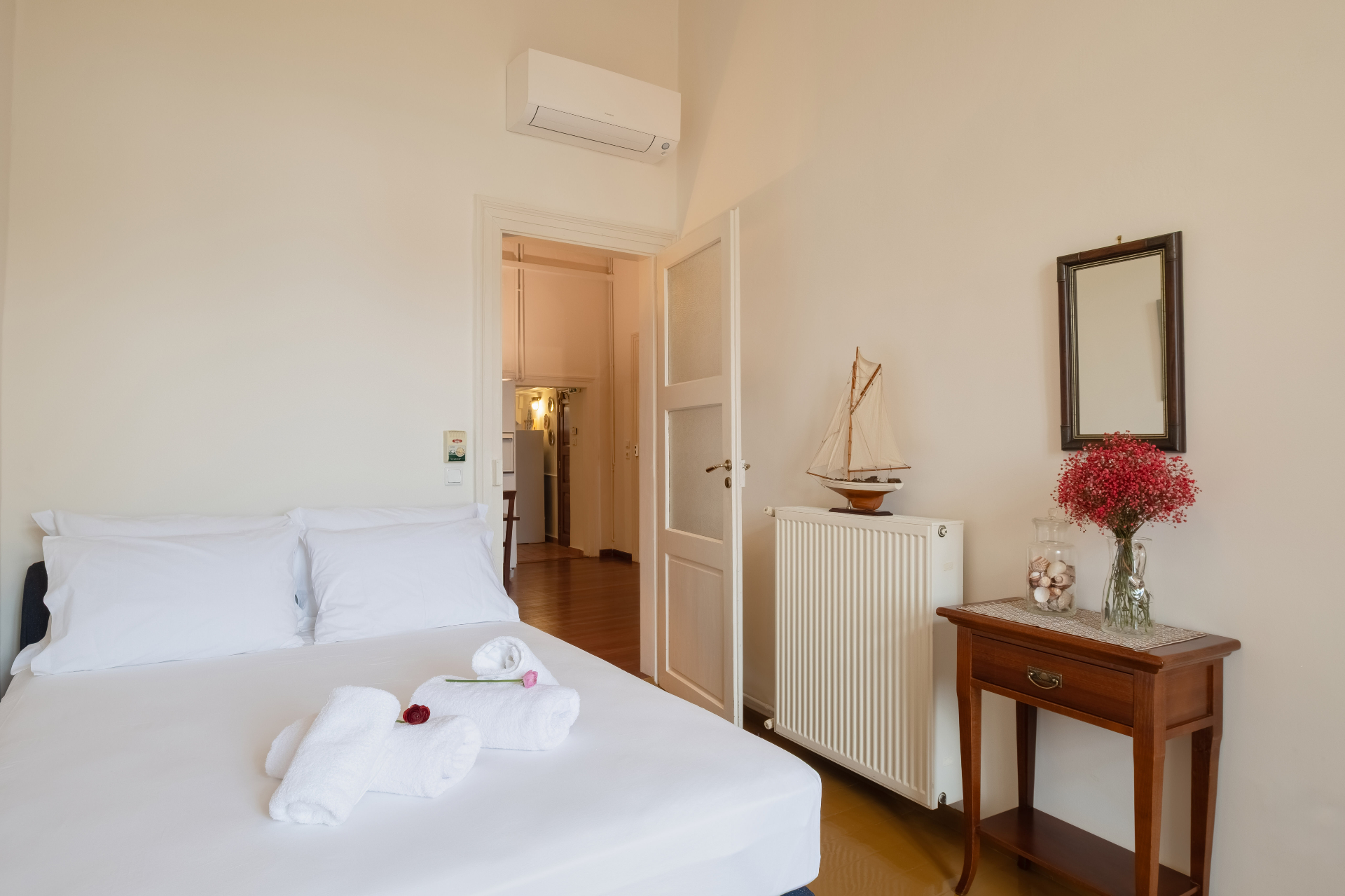 Bedroom detail with fresh linens and classic wooden furnishings.