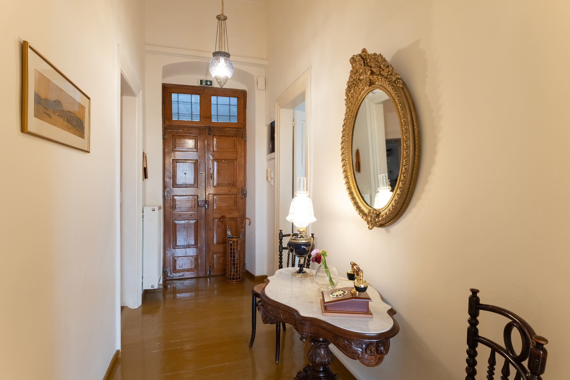 Entrance corridor with marble console table and ornate mirror.